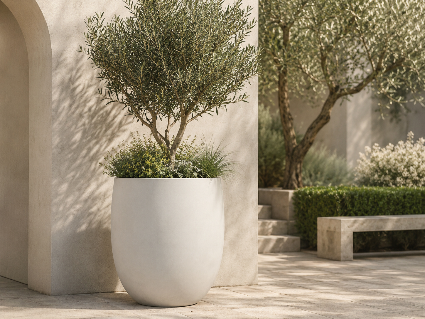 Smooth black round egg fiberclay planters on stone patio