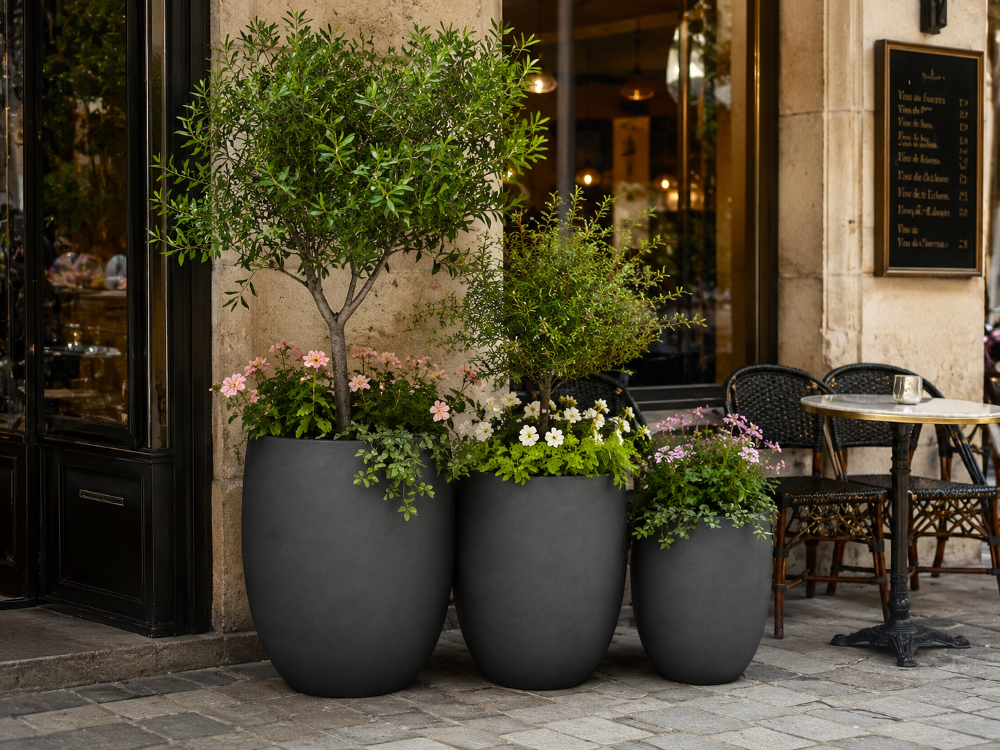 Smooth black round egg planters for cafe entrance