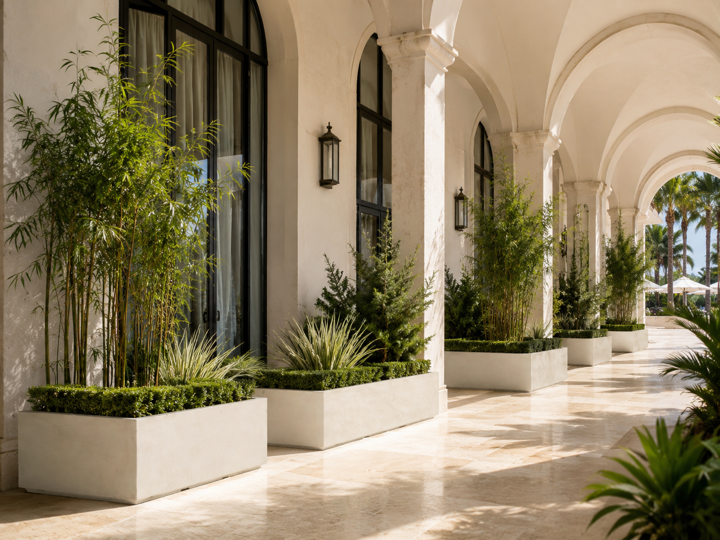 Large smooth white trough planters for hotel arcade and covered walkway landscaping