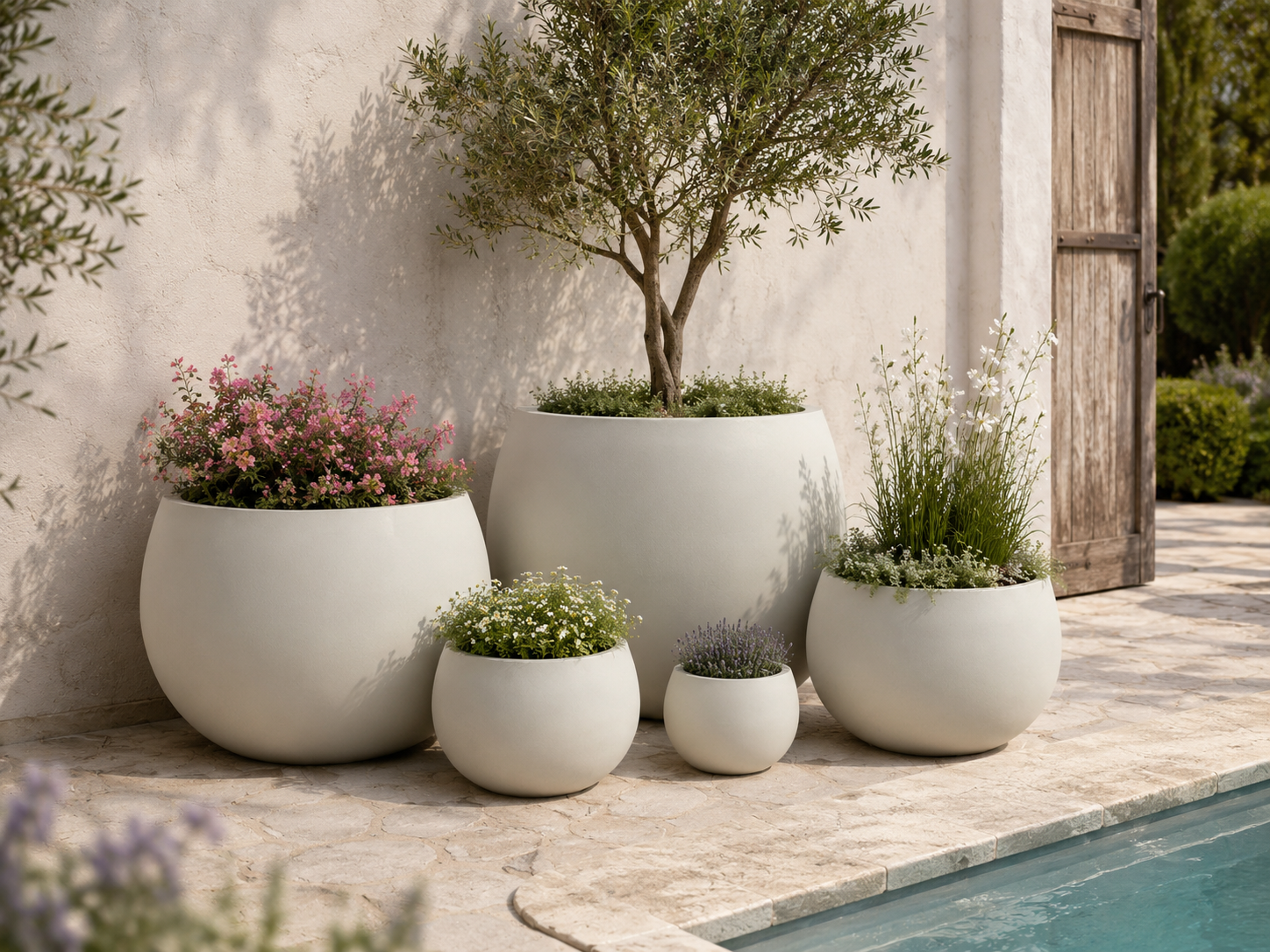 Outdoor fiberclay planter pots beside swimming pool patio